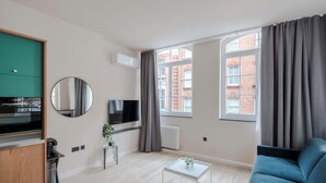 A modern living room with a sofa, a coffee table, a TV, and a window with curtains. - The Italian Collection - Soho - by Frankie (London)