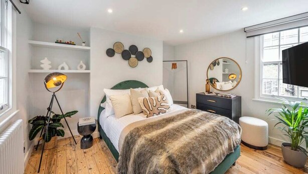 A modern bedroom with a bed, bedside table, lamp, and a large window. - The Pottter Edition - Covent Garden - by Frankie (London)