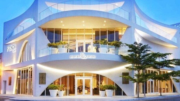 A modern building with a curved facade, large glass windows, and a sign that reads "Fendi Luxury Living". - Wynwood Escape
Built for long-term stay (Miami)