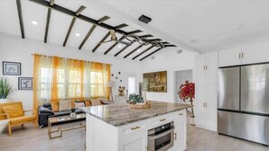 A modern kitchen with a central island, white cabinetry, and stainless steel appliances. - Wynwood Escape
Built for long-term stay (Miami)
