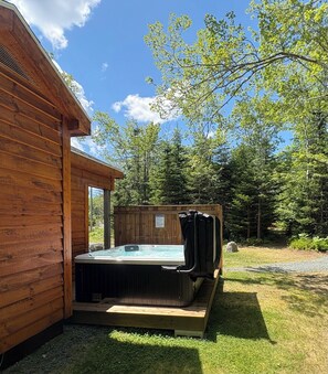 A wooden cabin with a hot tub in the backyard. - The Birch, West Porters Lake (West Porters Lake)