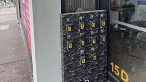 A hotel entrance with a numbered keypad for room access, a welcome sign, and a '15D' marking on the door. - Urban Sunlit Nest in the Heart of CBD (Auckland Central)