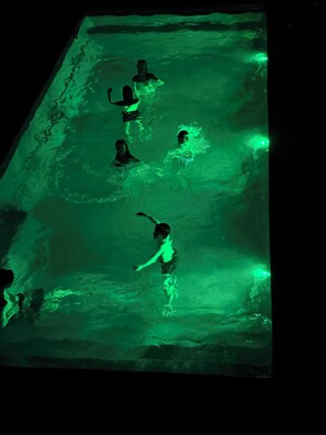 A swimming pool with multiple people.