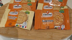 A collection of St. Michel biscuit packets on a wooden surface. - Modern 1-Bed Penthouse — Steps from Old Trafford (Stretford)