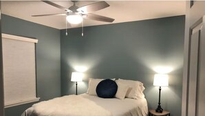 A bedroom with a bed, two bedside lamps, a ceiling fan, and a window with blinds. - 4-Bedroom Villa in Flagler Beach with priority beach access (Flagler Beach)