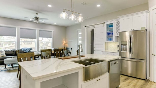 A modern kitchen with a large island, stainless steel appliances, and white cabinetry. - Spacious 4-bedroom house, with boat parking!!!Close to a boat ramp (Rockport)