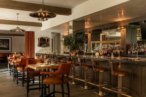 Un espace bar avec un comptoir, des tabourets et un menu de boissons.