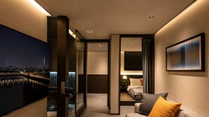 A hotel room with a bed, a sofa, a TV, and a painting. - Loop Seoul Hotel by Anook Seoul Gangnam 1 (Seoul)