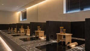 A modern bathroom with multiple sinks, wooden stools, and hourglasses. - Loop Seoul Hotel by Anook Seoul Gangnam 1 (Seoul)