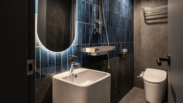 Deluxe (4 person) | Bathroom | Hair dryer, slippers, bidet, towels