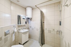 A small bathroom with a toilet, sink, and shower. - А17 Plovdiv Apartments Next to RowingChannel app12 (Plovdiv)