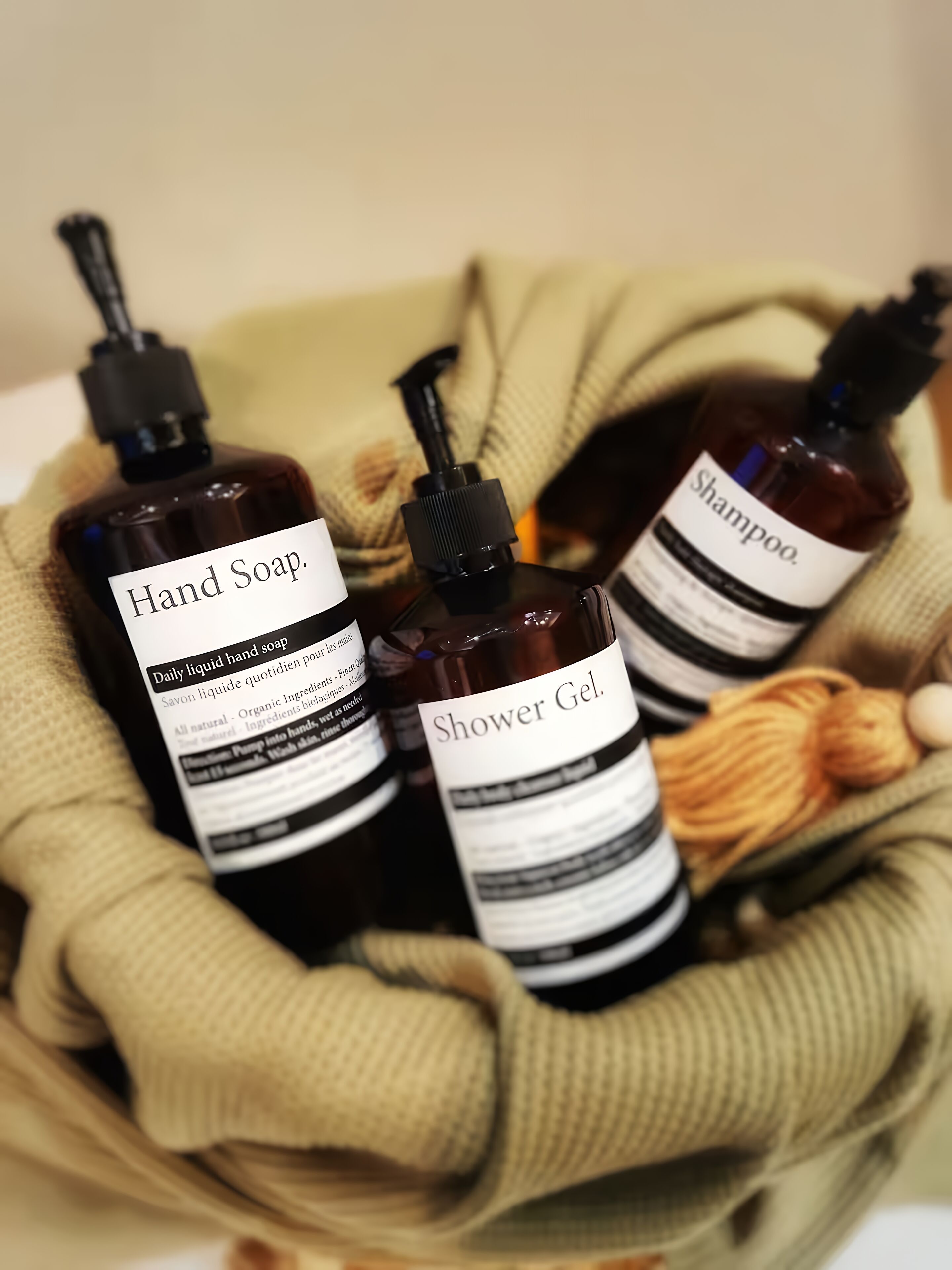 A basket containing bottles of hand soap and shower gel.