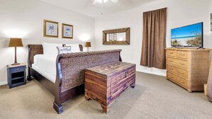 A hotel room with a bed, a nightstand, a dresser, a television, and a ceiling fan. - Private Beach Access-Pool-Central Destin BP1003 (Destin)