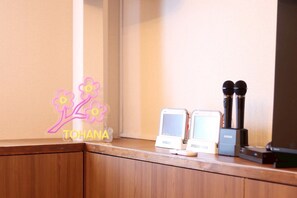 A wooden counter with two small electronic devices and a microphone stand. - TOHANASTYLE (Hanamaki)