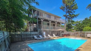A rectangular swimming pool with a wooden deck and lounge chairs. - HappyTauk - 4 BR Home Near Beach w/Private Pool - Dogs Allowed (Southern Shores)