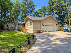 A residential property with a garage, a well-maintained lawn, and a wooden deck. - One Particular Harbour - 5 BR Single Level Ranch, Private Pool, Canalfront (Southern Shores)