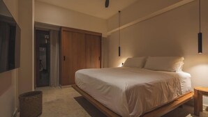 A bedroom with a bed, a ceiling fan, a wooden floor, a small table, and a wardrobe. - Luxury penthouse / Heart of Santa Marta (Santa Marta)