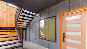 A staircase with a metal railing leading to a wooden floor.