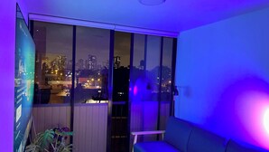 A balcony with a city view, a sofa, and potted plants. - Digital Nomad, Expat and Foreign Student Haven! (Pueblo Libre)