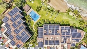 An aerial view of a resort with multiple buildings, a swimming pool, and a beach. - OCEANFRONT with Private Beach! Hale Mahina A206 (Lahaina)