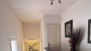 A staircase with a striped carpet, a white wall, a door, and a framed picture. - Typically Provençal, located in the hills above Les Issambres, 6+1 (LES ISSAMBRES)