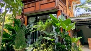A two-story building with a balcony, surrounded by lush greenery. - Ratu Roso Resort (Ulesari)