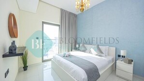 A modern bedroom with a large bed, a nightstand, a potted plant, and a window with curtains. - Bloomfields Modern 1Bedroom In Wavez (Dubai)