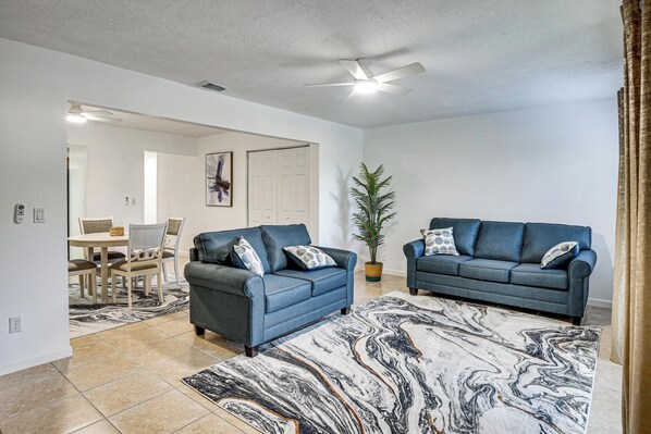 A living room with two sofas, a coffee table, and a large marble-patterned rug. - Sun, Sand & Poolside Relaxation! Ormond Beach Unit (Ormond Beach)