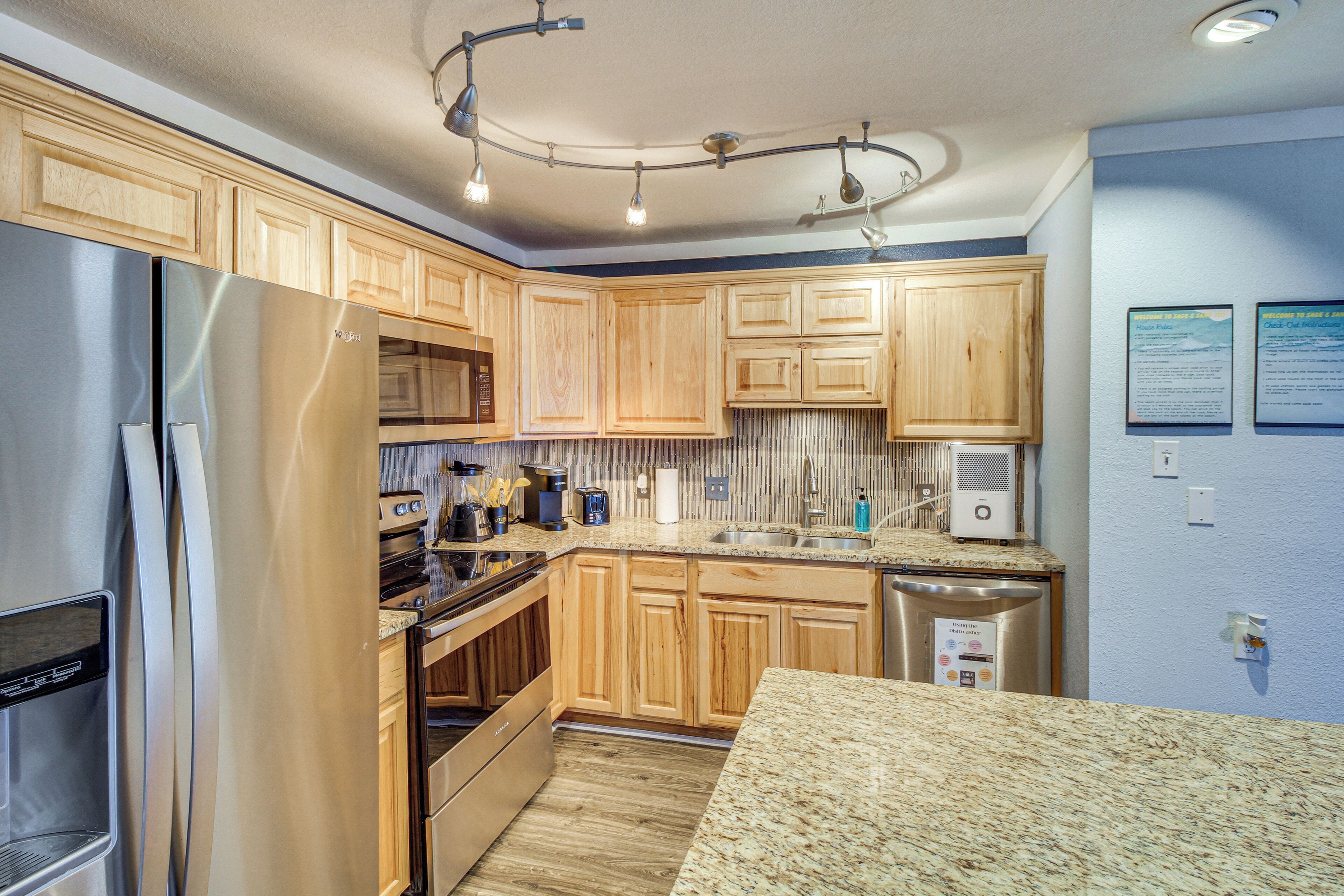 A modern kitchen with wooden cabinets, stainless steel appliances, granite countertops, and a built-in oven.