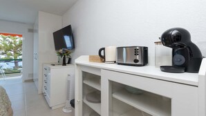 A kitchenette with a microwave, toaster, coffee maker, and a small refrigerator. - Ocean View 3 (Los Cristianos)