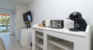 A kitchenette with a microwave, toaster, coffee maker, and a small refrigerator. - Ocean View 3 (Los Cristianos)