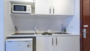 A compact kitchenette with a microwave, sink, and a small refrigerator. - Ocean View 3 (Los Cristianos)