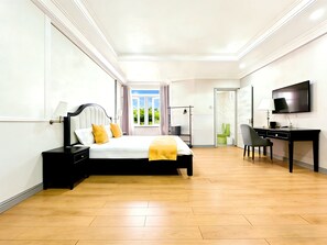 A modern hotel room with a large bed, a desk, a television, and a bathroom visible through an open door. - JUN YUE GRA Lagos hotel (Lagos)