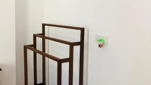 A room with a wooden bookshelf against the wall. - Devon Surf  Inn : Deluxe Double Room (Dikwella)