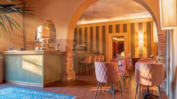 A bar area with a counter, bar stools, and a blue rug.