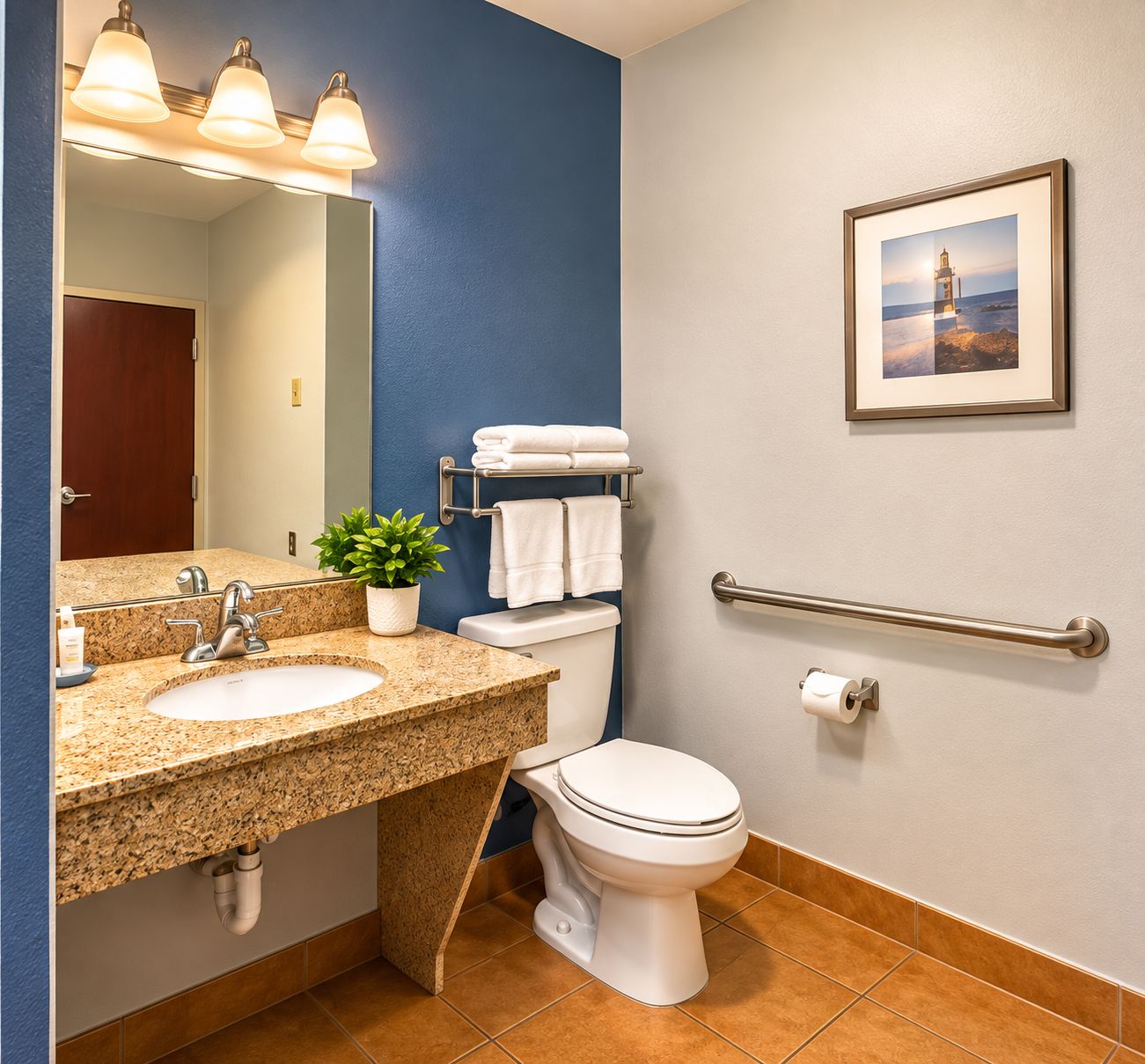 A bathroom with two sinks, a toilet, a towel rack, a handrail, and a framed picture on the wall.