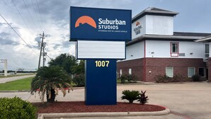 A Suburban Studios hotel sign with a number 1007.