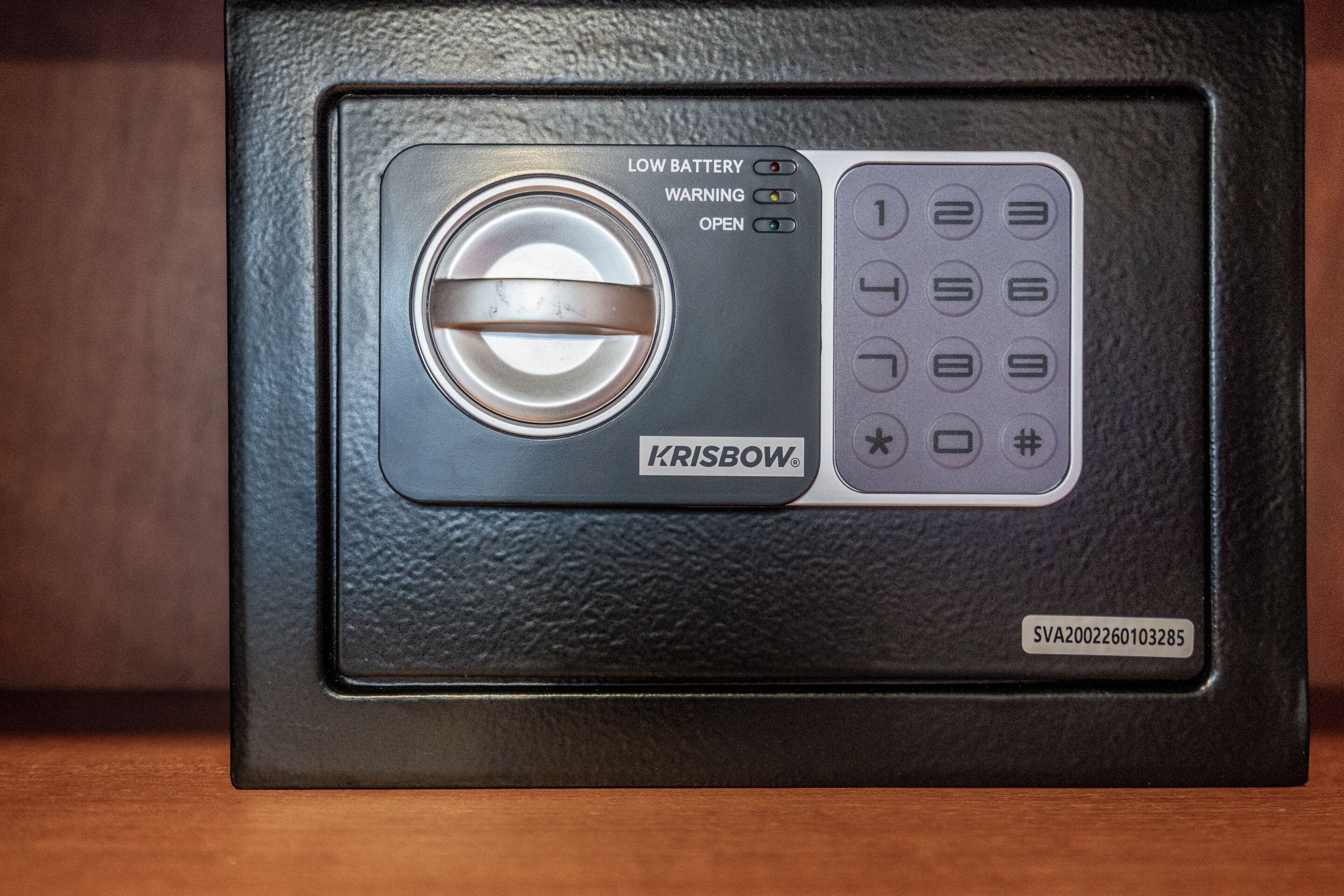 A black electronic device with a keypad and a circular dial, labeled 'KRISBOW.'