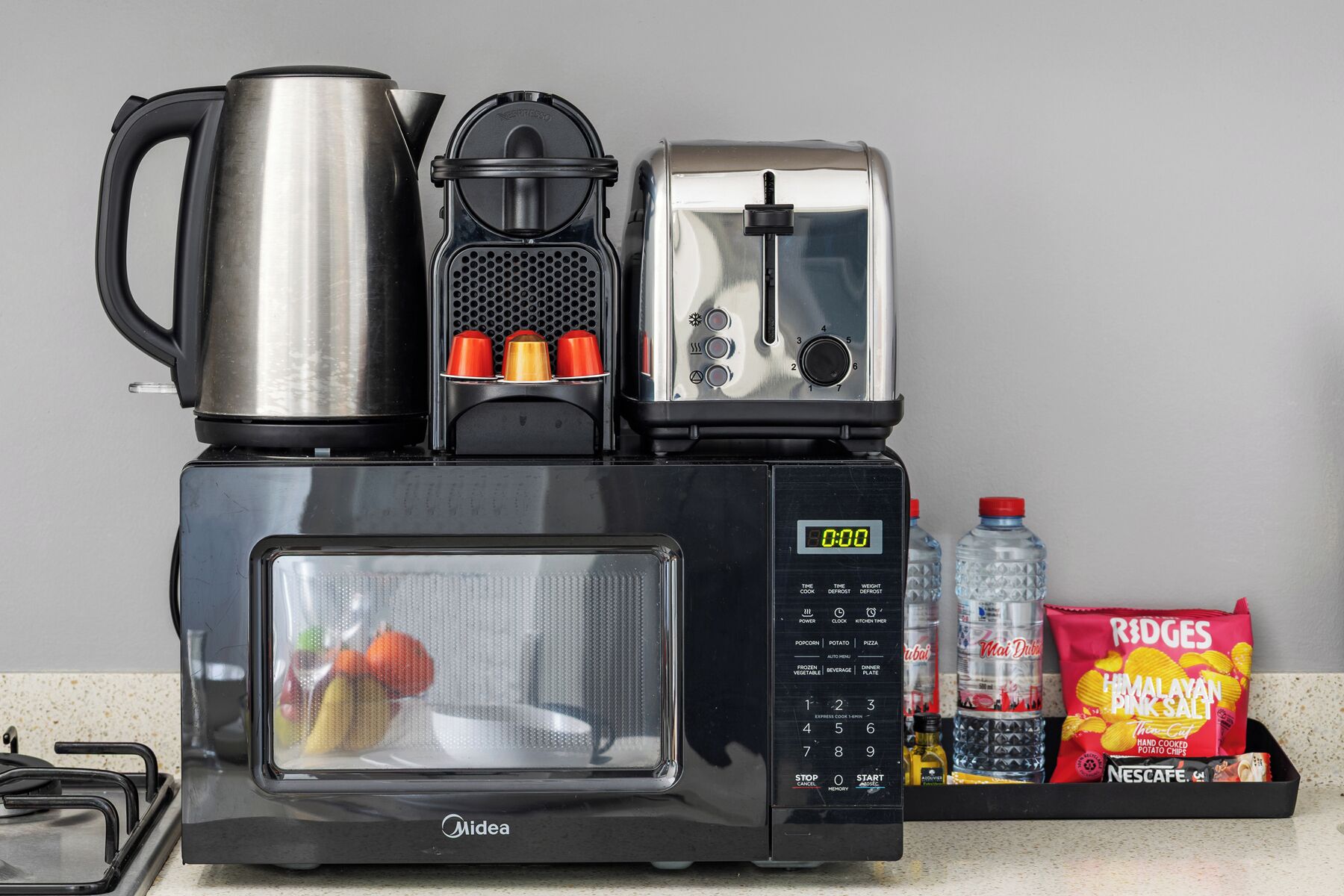 A kitchen setup with a coffee maker, toaster, and microwave.