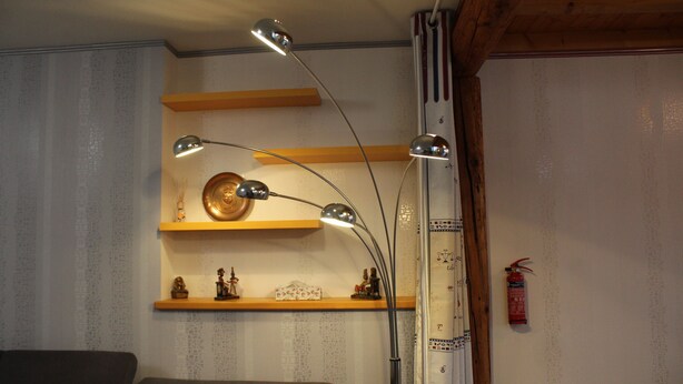 A room with a sofa, a wall-mounted shelf with decorative items, and a fire extinguisher. - Demeure Ferralaise, house with tropézienne in  heart of the Corbières mountains (Ferrals-les-Corbières)