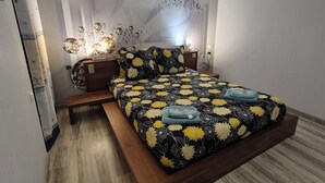A modern bedroom with a bed, bedside tables, and a wall with decorative elements. - Demeure Ferralaise, house with tropézienne in  heart of the Corbières mountains (Ferrals-les-Corbières)
