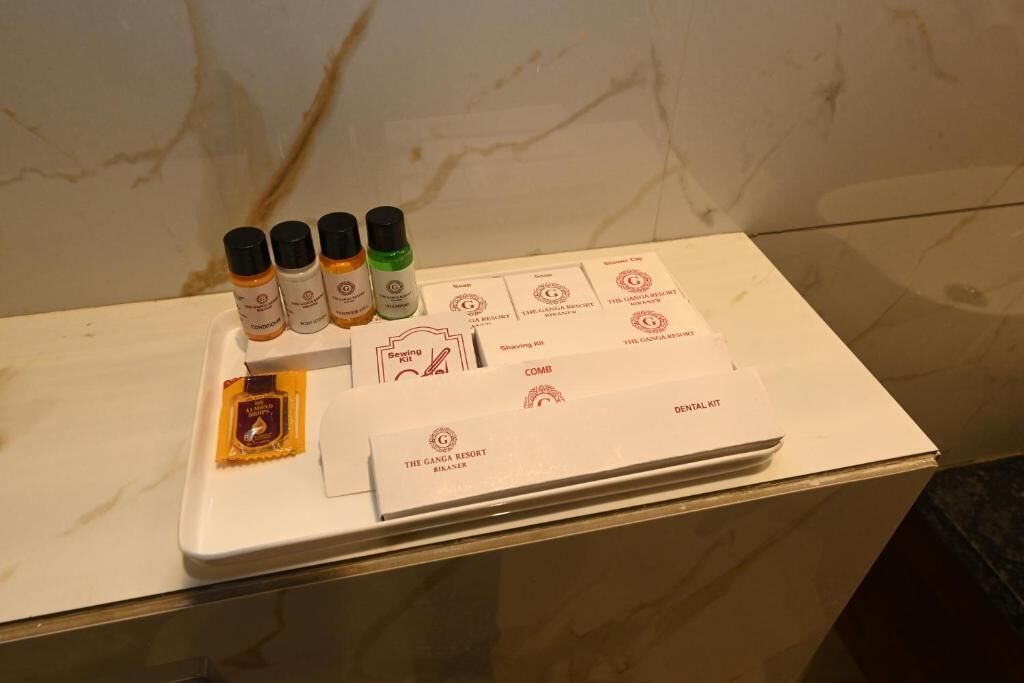 A bathroom counter with toiletries and a dental kit.