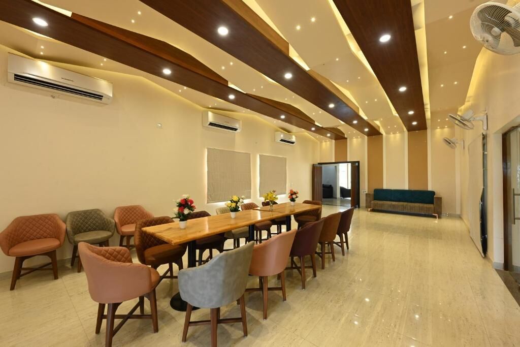 A conference room with a long table, multiple chairs, and ceiling fans.