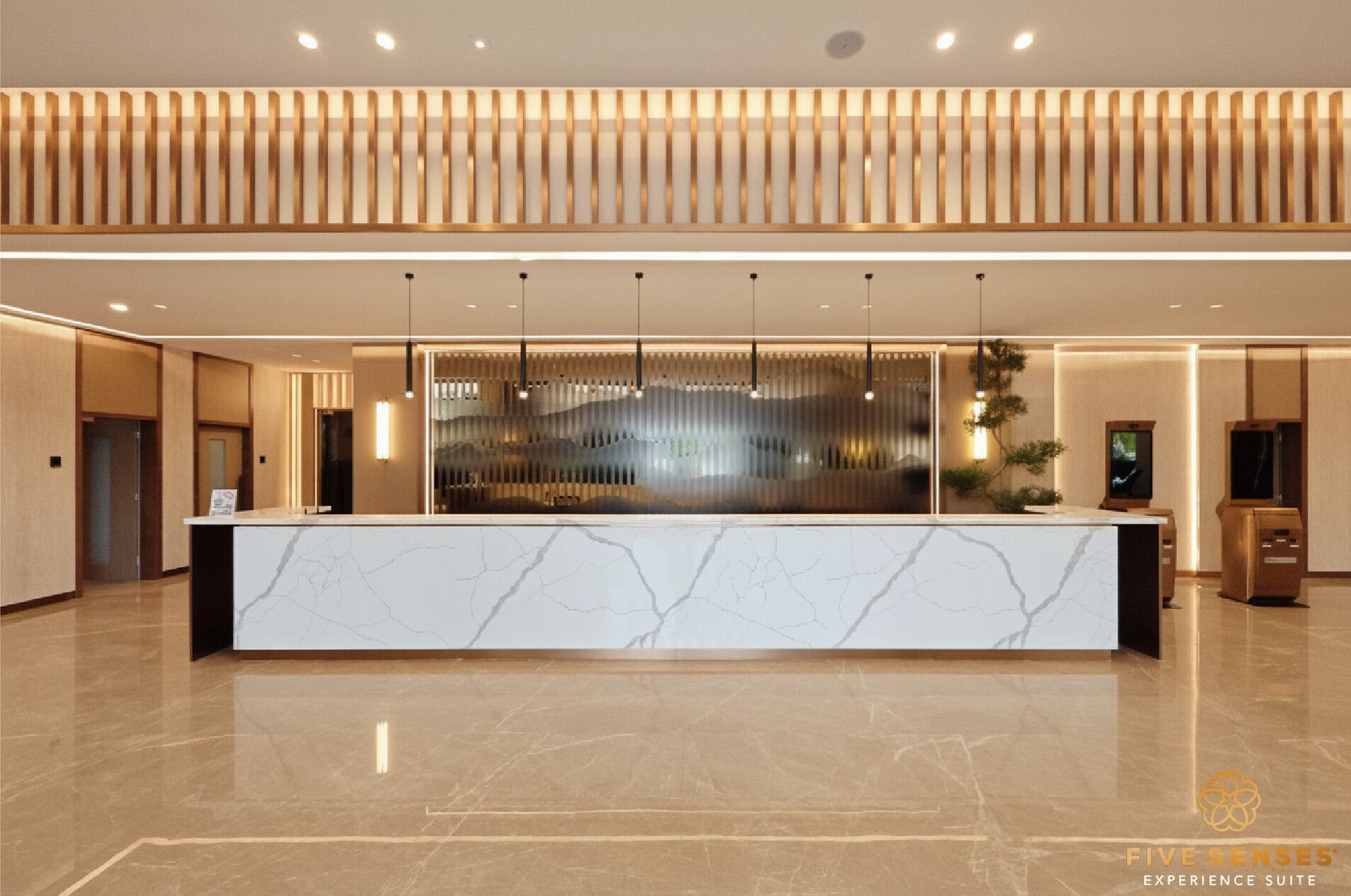 A reception area with a marble counter, pendant lighting, and a modern design.