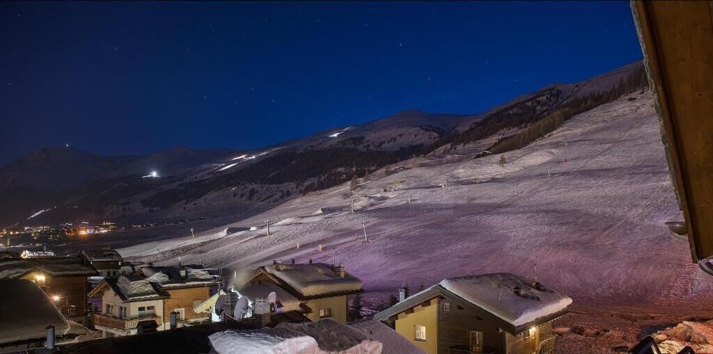 A snow-covered mountain with a small village at the base.