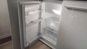 An open refrigerator with multiple shelves and a freezer compartment. - Studio room near Koblenz (Sankt Sebastian)