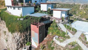 A modern multi-story house with a flat roof, large windows, and a balcony. - Native Residence Casa 4 (Playas de Rosarito)