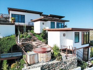 A modern two-story house with a stone staircase leading to a wooden deck. - Native Residence Casa 5 (Playas de Rosarito)