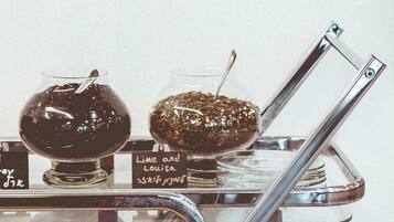 A metallic cart with two glass containers labeled "Lime and Louisa" and "Lime and Louisa."