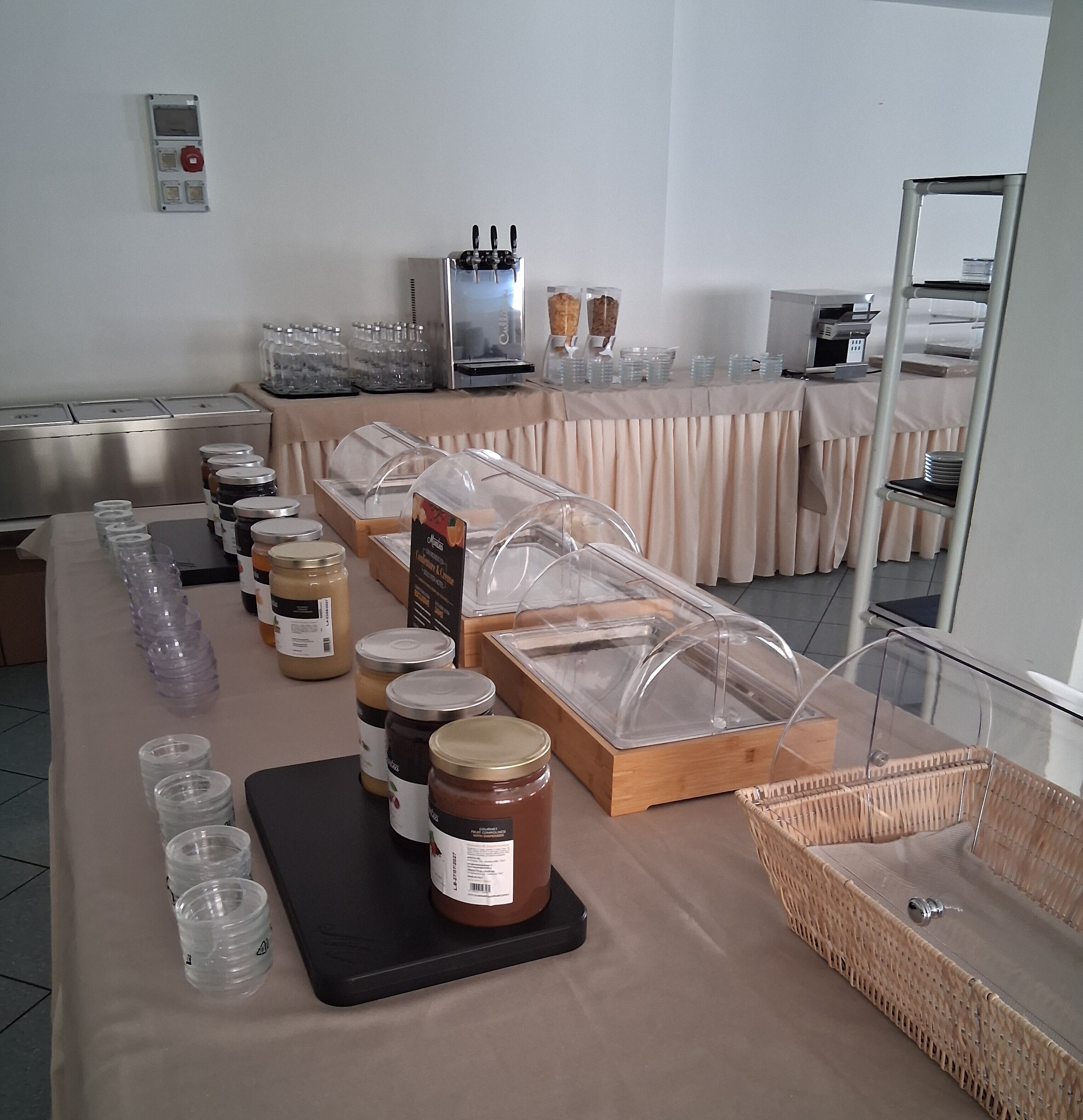 A buffet setup with various food items and condiments.